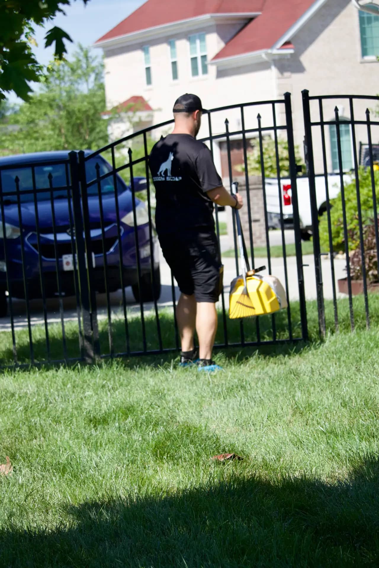 Commercial route cleanup by Doggy Scoop Doggy Scoop technician servicing a commercial property gate area