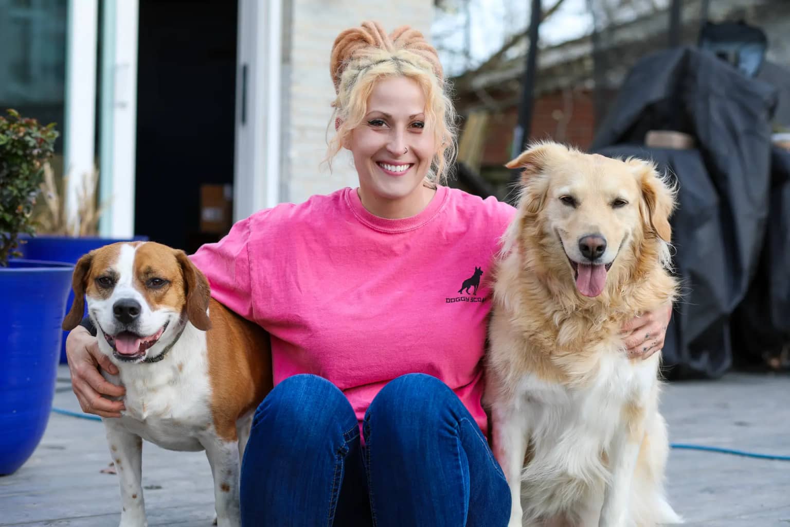 Contact Doggy Scoop for local pet waste removal Doggy Scoop team member with dogs ready to help customers